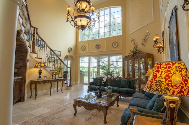 143 SE Bella Strano, Port Saint Lucie, FL 34984 - living area with a towering ceiling, stairs, light tile patterned floors, a chandelier, and ornamental molding