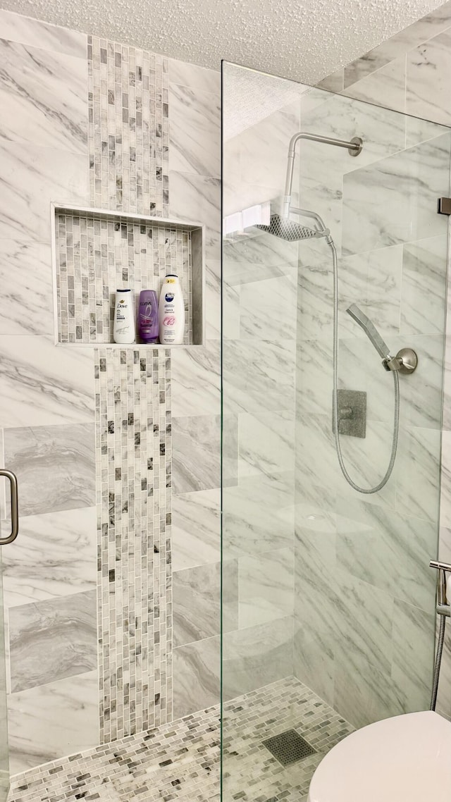 1053 Manor Dr Unit 14-A, Palm Springs, FL 33461 - full bath featuring a stall shower, a textured ceiling, and toilet