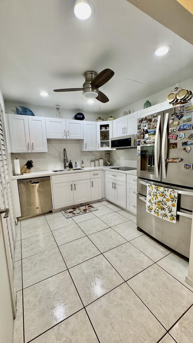 1053 Manor Dr Unit 14-A, Palm Springs, FL 33461 - kitchen featuring appliances with stainless steel finishes, a sink, white cabinetry, a ceiling fan, and light countertops