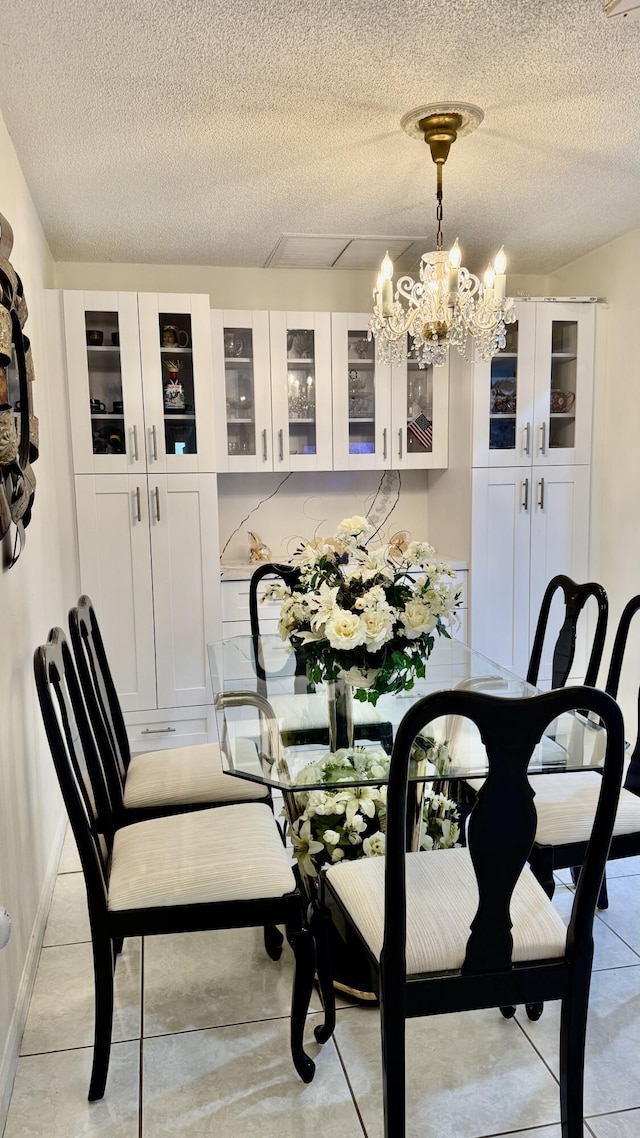 1053 Manor Dr Unit 14-A, Palm Springs, FL 33461 - dining area featuring a textured ceiling and a chandelier