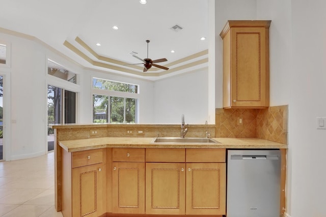 9400 Briarcliff Trce, Port Saint Lucie, FL 34986 - kitchen with dishwasher, a sink, ceiling fan, a raised ceiling, and light countertops
