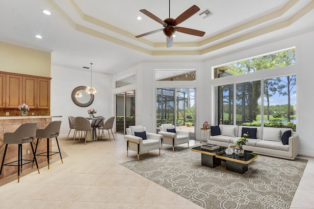 9400 Briarcliff Trce, Port Saint Lucie, FL 34986 - living room with a tray ceiling, a towering ceiling, light tile patterned flooring, ceiling fan, and recessed lighting
