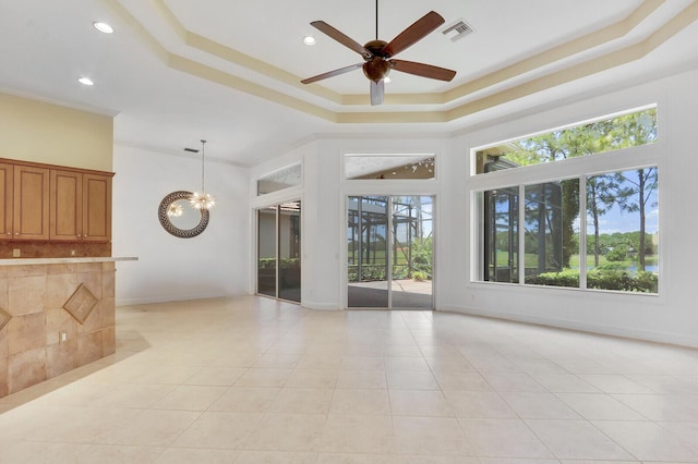 9400 Briarcliff Trce, Port Saint Lucie, FL 34986 - spare room featuring a tray ceiling, a ceiling fan, light tile patterned floors, a chandelier, and recessed lighting