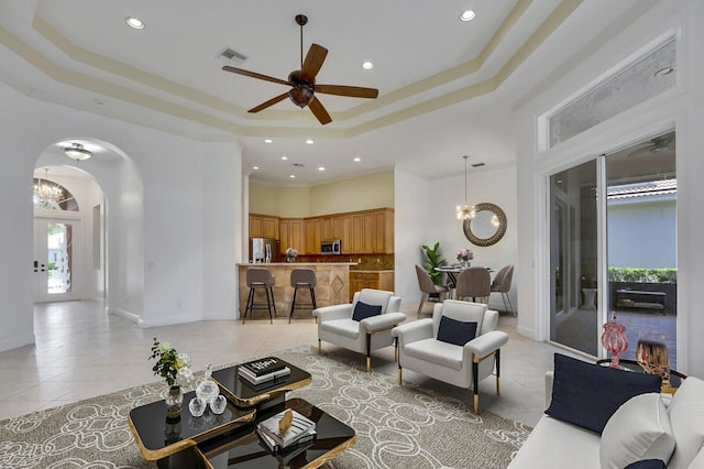 9400 Briarcliff Trce, Port Saint Lucie, FL 34986 - living area featuring light tile patterned floors, a tray ceiling, recessed lighting, a ceiling fan, and a towering ceiling
