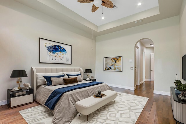 9400 Briarcliff Trce, Port Saint Lucie, FL 34986 - bedroom with arched walkways, hardwood / wood-style flooring, baseboards, and recessed lighting