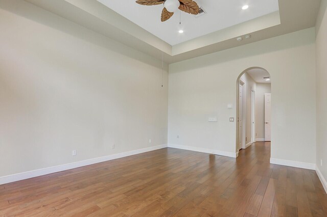 9400 Briarcliff Trce, Port Saint Lucie, FL 34986 - unfurnished room featuring arched walkways, a ceiling fan, wood finished floors, baseboards, and recessed lighting