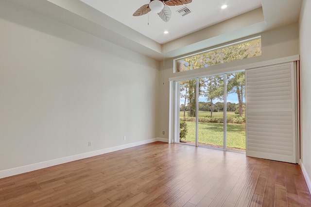 9400 Briarcliff Trce, Port Saint Lucie, FL 34986 - spare room featuring a ceiling fan, wood finished floors, baseboards, a high ceiling, and recessed lighting