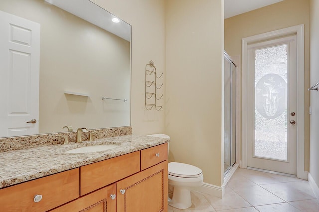 9400 Briarcliff Trce, Port Saint Lucie, FL 34986 - full bath with a shower stall, toilet, tile patterned floors, vanity, and baseboards