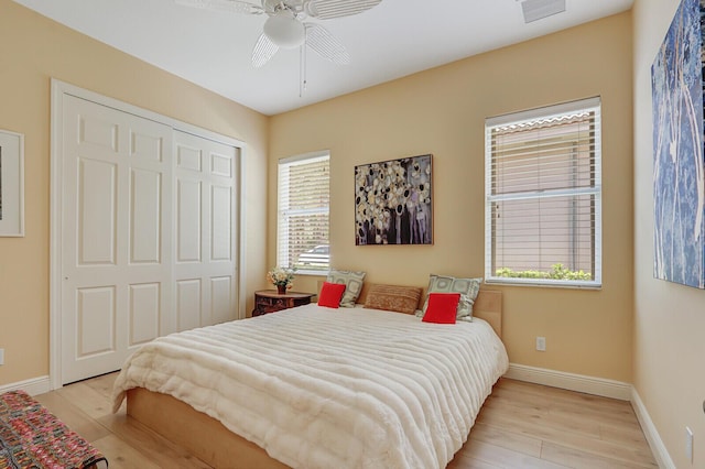 9400 Briarcliff Trce, Port Saint Lucie, FL 34986 - bedroom featuring light wood-type flooring, a closet, baseboards, and ceiling fan