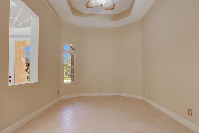9400 Briarcliff Trce, Port Saint Lucie, FL 34986 - tiled spare room with a raised ceiling, ceiling fan, and baseboards