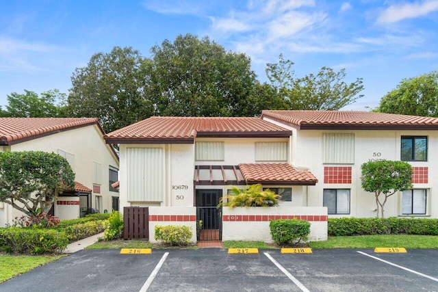 10679 Ocean Palm Way Unit 101, Boynton Beach, FL 33437 - view of property with uncovered parking and a fenced front yard