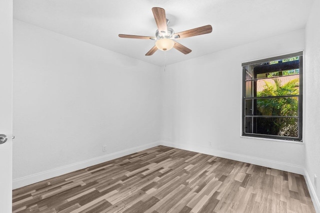 10679 Ocean Palm Way Unit 101, Boynton Beach, FL 33437 - empty room with wood finished floors, ceiling fan, and baseboards