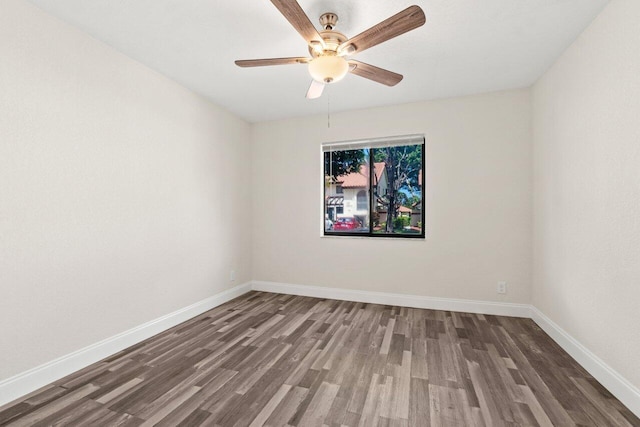 10679 Ocean Palm Way Unit 101, Boynton Beach, FL 33437 - spare room with wood finished floors, baseboards, and ceiling fan