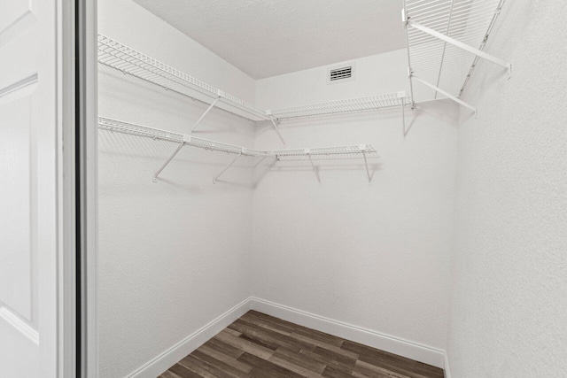 10679 Ocean Palm Way Unit 101, Boynton Beach, FL 33437 - walk in closet featuring dark wood-style flooring