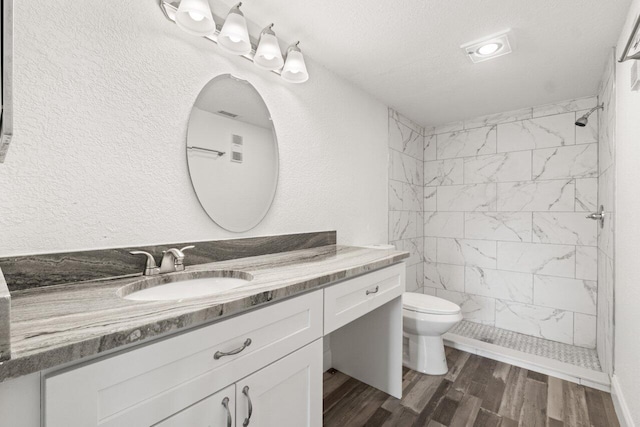 10679 Ocean Palm Way Unit 101, Boynton Beach, FL 33437 - full bathroom featuring toilet, wood finished floors, tiled shower, and vanity