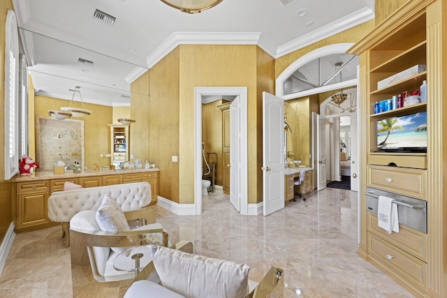living area with crown molding, light marble finish flooring, wood walls, and baseboards