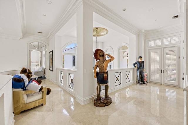 entrance foyer with marble tiled floors, ornamental molding, and french doors