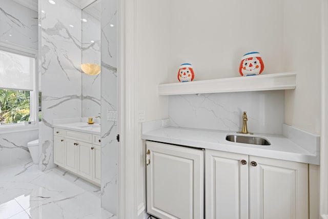 bar area featuring a sink and light marble finish flooring