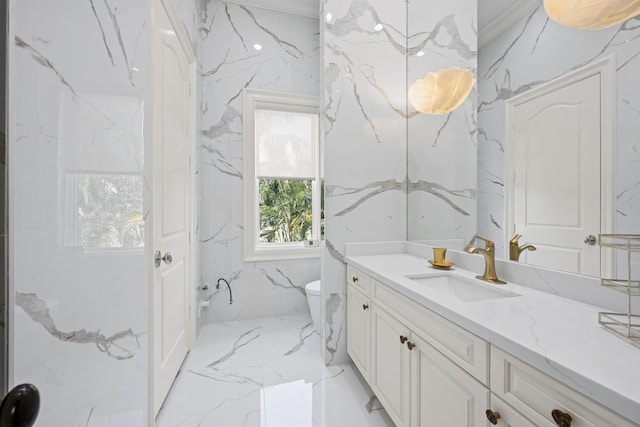 bathroom with marble tiled floors, vanity, toilet, and stone wall