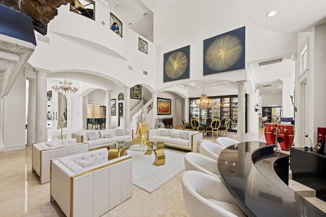 living room featuring decorative columns, a chandelier, a towering ceiling, and arched walkways