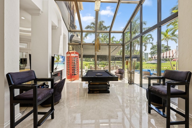 playroom with a high ceiling, expansive windows, and billiards table