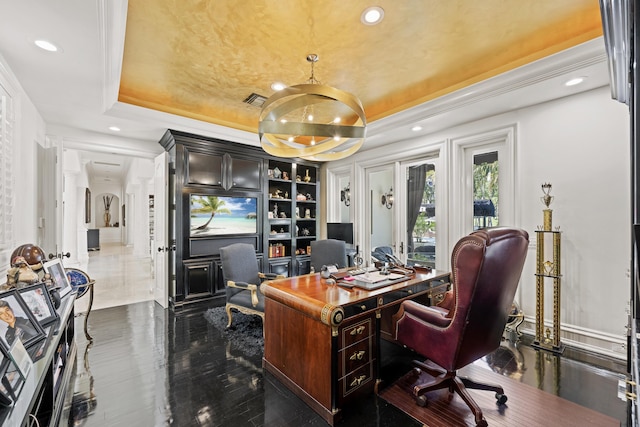 office space with a raised ceiling, recessed lighting, and built in shelves