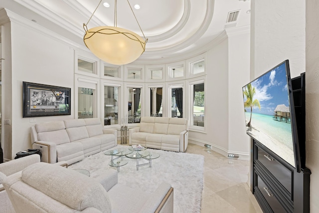 living room with crown molding, a tray ceiling, a towering ceiling, and baseboards
