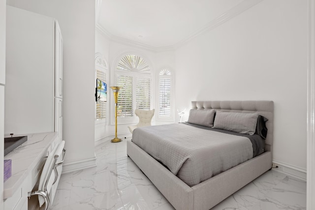bedroom with light marble finish floors, ornamental molding, and baseboards