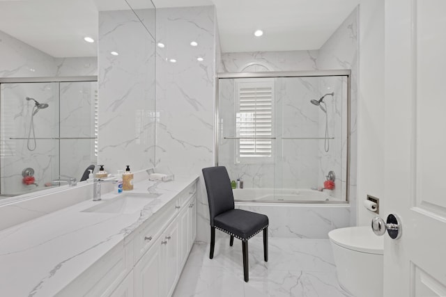 bathroom with marble tiled flooring, toilet, vanity, enclosed tub / shower combo, and recessed lighting