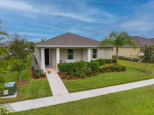 1480 Earlsferry Ave, Vero Beach, FL 32966 - view of front facade with stucco siding, a front yard, covered porch, and roof with shingles