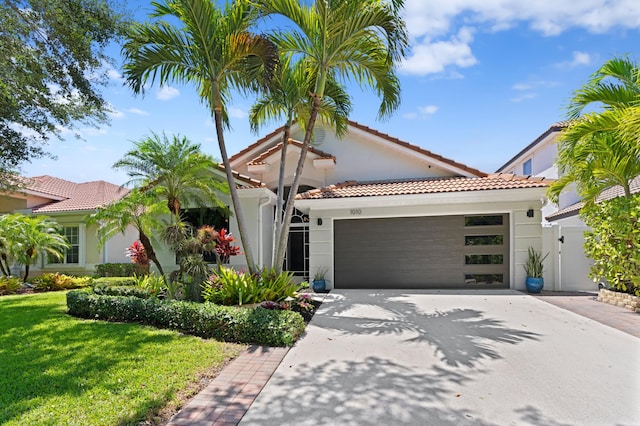 1010 Delray Lakes Dr, Delray Beach, FL 33444 - mediterranean / spanish house with a tiled roof, concrete driveway, an attached garage, and a front lawn
