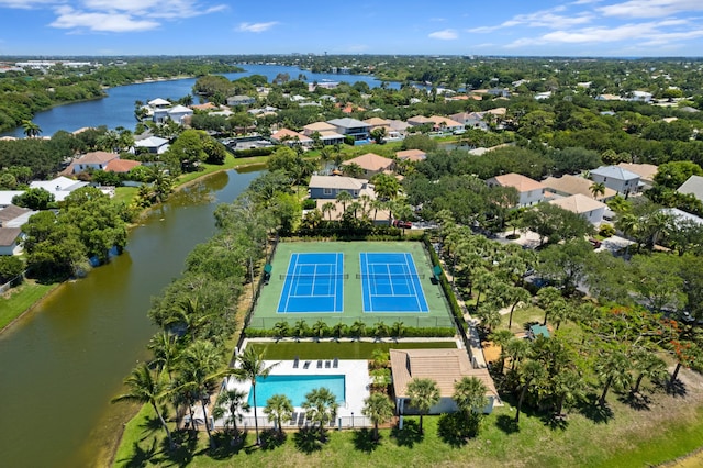 1010 Delray Lakes Dr, Delray Beach, FL 33444 - aerial perspective of suburban area featuring a pool, a nearby body of water, and a tree filled landscape