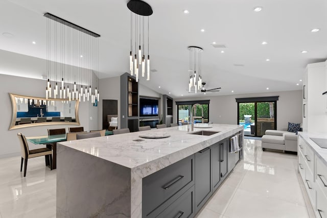 1010 Delray Lakes Dr, Delray Beach, FL 33444 - kitchen featuring open floor plan, a sink, a large island with sink, white cabinetry, and light stone counters