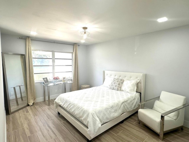 bedroom featuring wood finished floors and baseboards