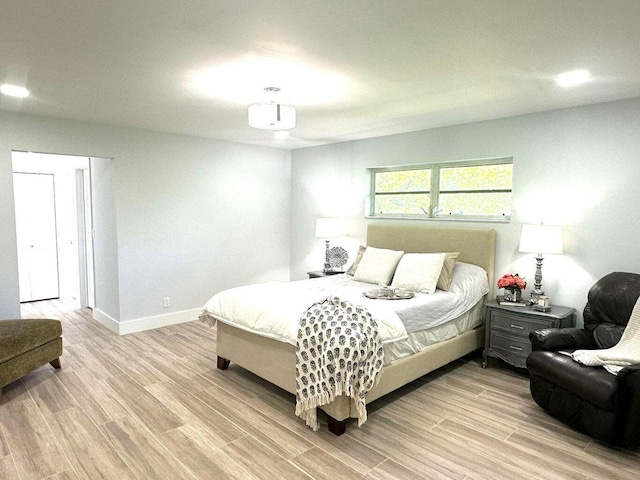 bedroom with light wood-style flooring and baseboards