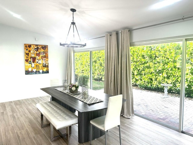 dining space featuring a chandelier and wood finished floors