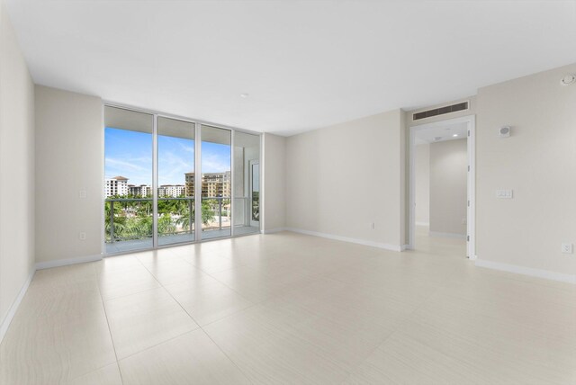 220 SE Mizner Blvd Unit 609, Boca Raton, FL 33432 - unfurnished room featuring a wall of windows and baseboards