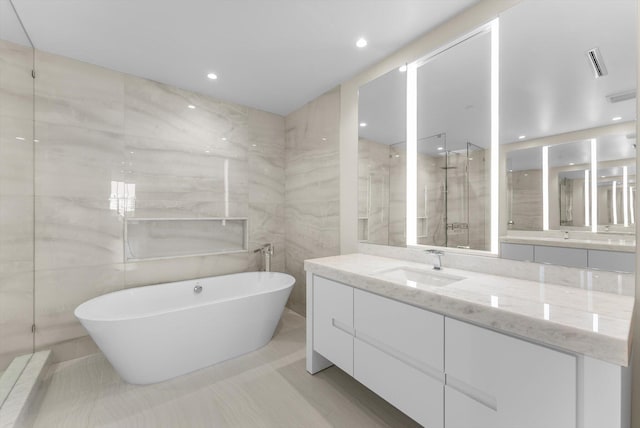 220 SE Mizner Blvd Unit 609, Boca Raton, FL 33432 - full bath with a freestanding bath, vanity, tile walls, a walk in shower, and recessed lighting