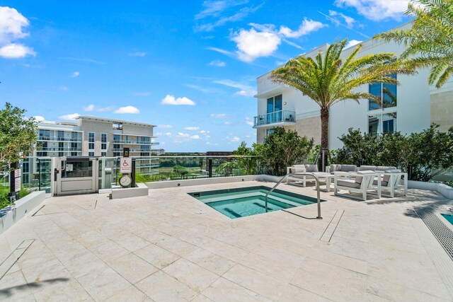 220 SE Mizner Blvd Unit 609, Boca Raton, FL 33432 - view of swimming pool featuring a hot tub and an outdoor living space