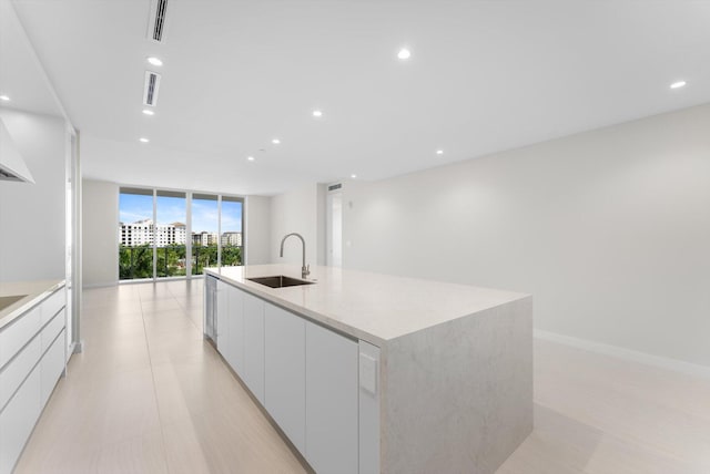 220 SE Mizner Blvd Unit 609, Boca Raton, FL 33432 - kitchen with a sink, modern cabinets, a wall of windows, white cabinetry, and open floor plan