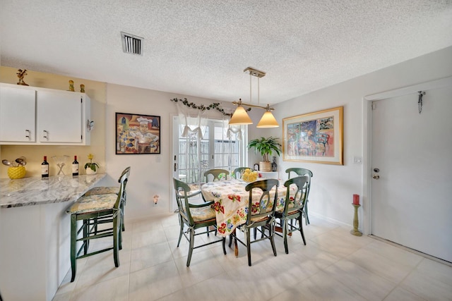 9152 Affirmed Ln, Boca Raton, FL 33496 - dining space featuring a textured ceiling and baseboards