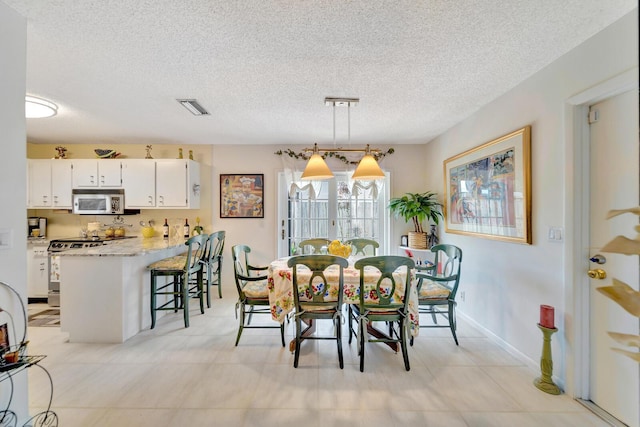 9152 Affirmed Ln, Boca Raton, FL 33496 - dining space with a textured ceiling and baseboards
