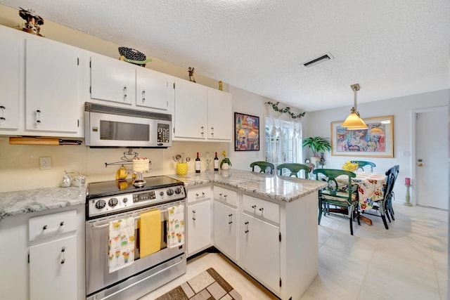 9152 Affirmed Ln, Boca Raton, FL 33496 - kitchen featuring stainless steel appliances, a textured ceiling, a peninsula, white cabinets, and pendant lighting
