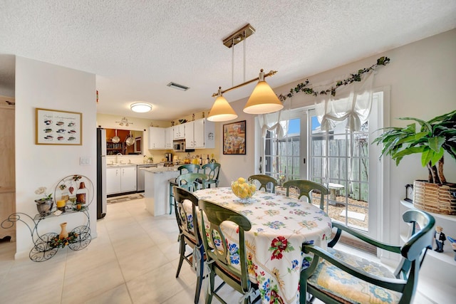 9152 Affirmed Ln, Boca Raton, FL 33496 - dining area with a textured ceiling and light tile patterned flooring