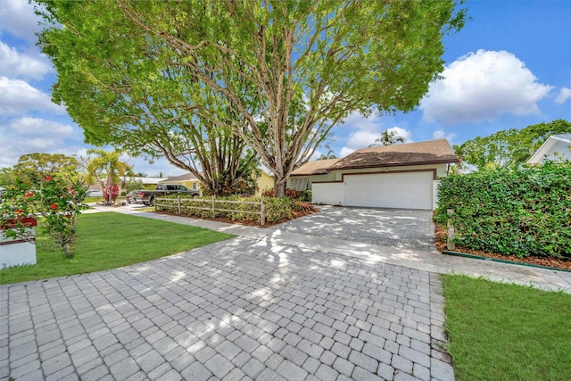 9152 Affirmed Ln, Boca Raton, FL 33496 - view of property hidden behind natural elements with a garage, a front yard, and decorative driveway