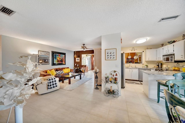 9152 Affirmed Ln, Boca Raton, FL 33496 - dining space with ceiling fan and a textured ceiling