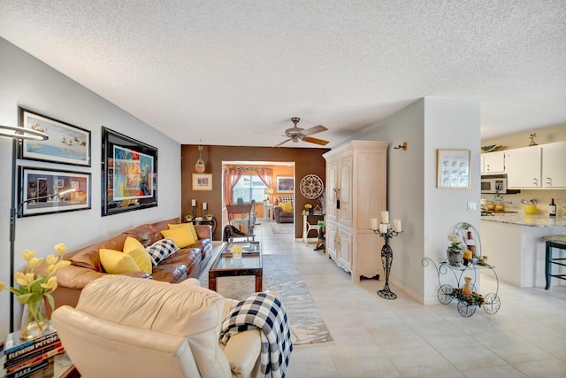 9152 Affirmed Ln, Boca Raton, FL 33496 - living area with a textured ceiling, a ceiling fan, light tile patterned floors, and baseboards