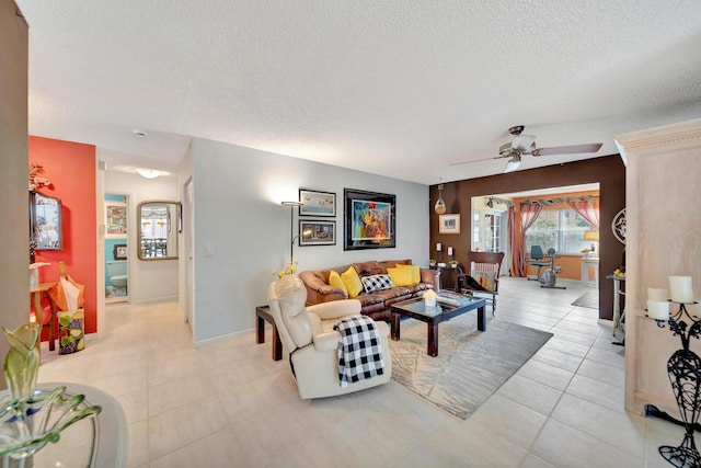 9152 Affirmed Ln, Boca Raton, FL 33496 - living area featuring a textured ceiling, ceiling fan, baseboards, and light tile patterned flooring