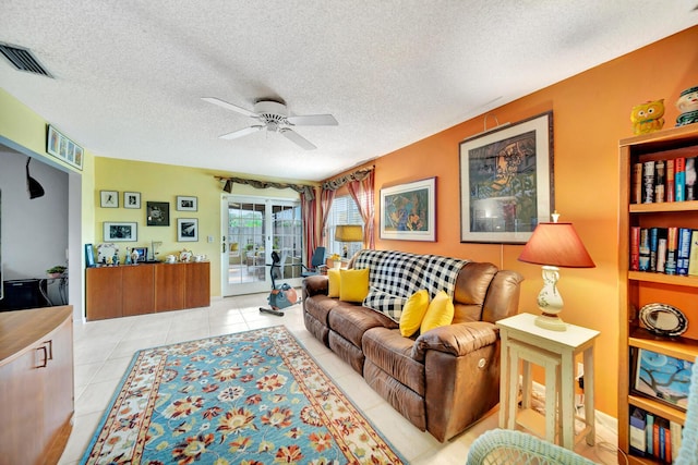 9152 Affirmed Ln, Boca Raton, FL 33496 - living room featuring a ceiling fan, a textured ceiling, and light tile patterned floors