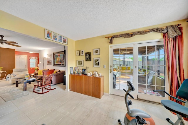 9152 Affirmed Ln, Boca Raton, FL 33496 - living room featuring a ceiling fan, a textured ceiling, and light tile patterned floors